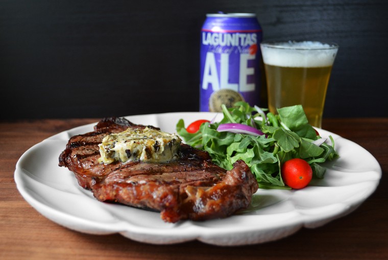 A cook's canvas Grilled Ribeye Steak with Charred Scallion Citrus Compound Butter